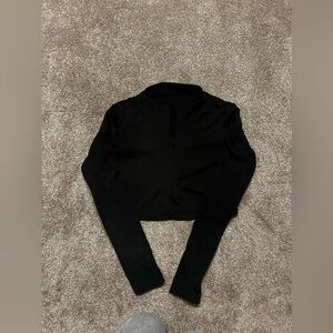 Black quarter zip cropped sweater with fleece interior.